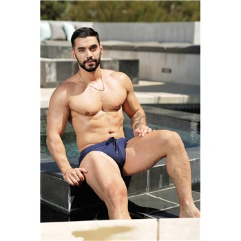 Topless male posed seated displaying chest
