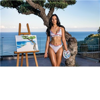 Brunette female posed wearing lingerie beside painting