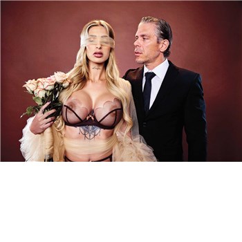 Blonde female posed blindfolded holding flowers with male