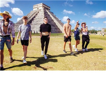 Clothed males walking outdoors pyramid in background