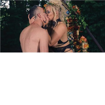 Blonde female kissing topless male