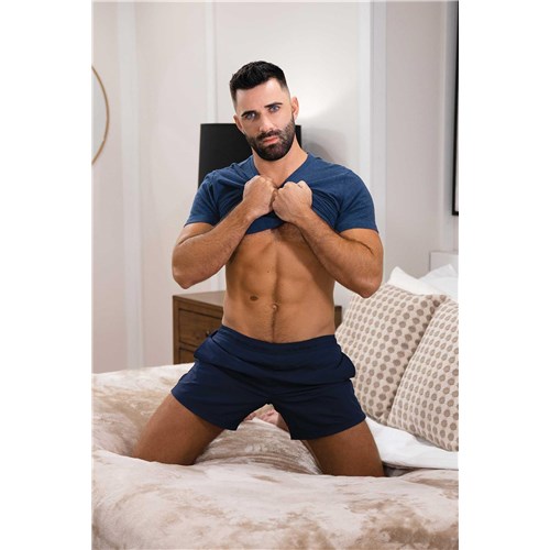 Topless male posed on bed