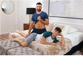 Two males lounging on bed
