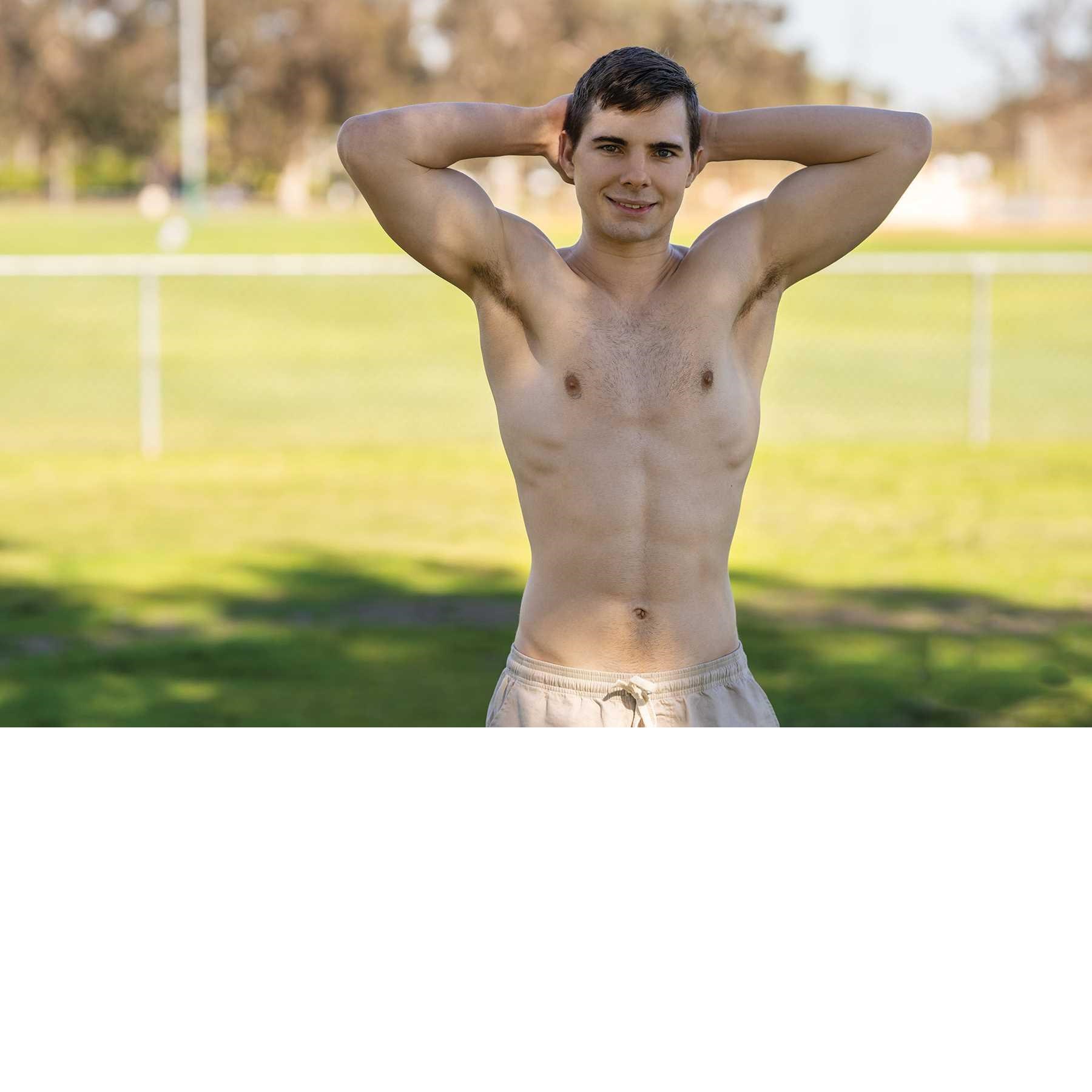 Topless male posed outdoors