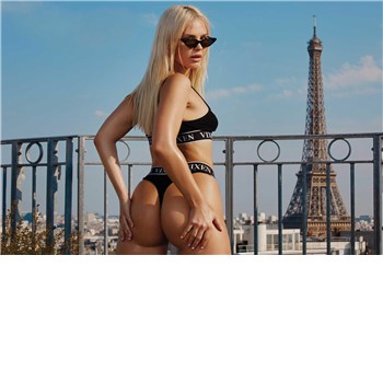 Blonde female posed wearing lingerie displaying rear