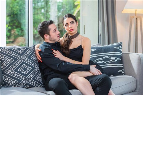 Clothed male caressing  clothed female on couch