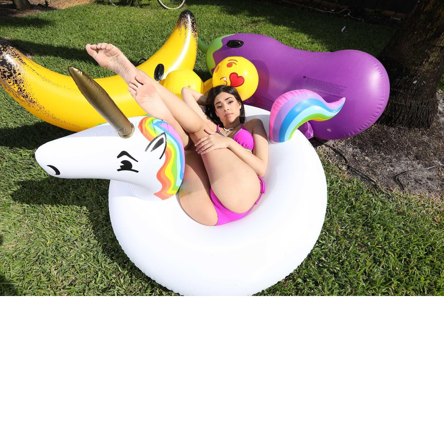 Brunette female posed wearing bikini lounging in float toy
