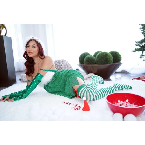 Brunette female posed lounging wearing Christmas elf attire