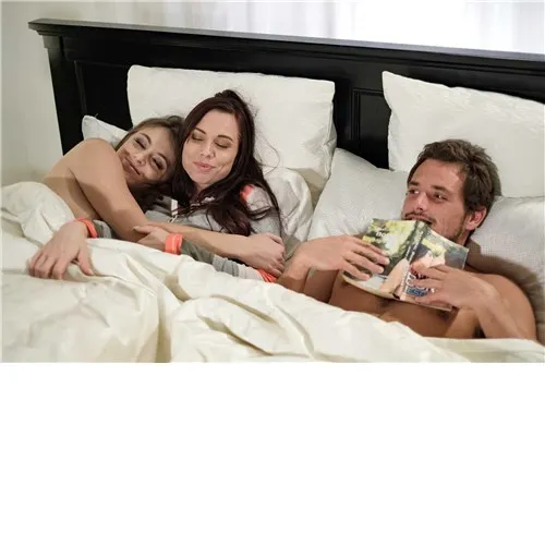 Two brunette females with male in bed